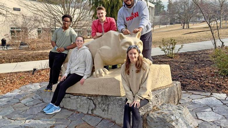 Berks student members of the team are pictured by the Lion Shrine.